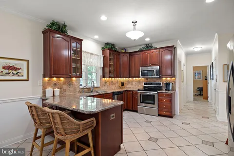 a kitchen with stainless steel appliances a refrigerator and a stove