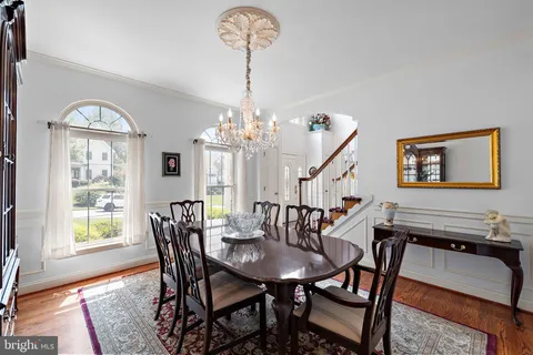 a view of a dining room with furniture large windows and wooden floor