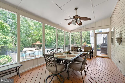 a living room with furniture ceiling fan and a window