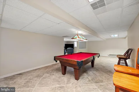 an aerial view of a house with a swimming pool outdoor seating and yard