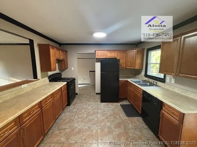 a view of a kitchen with stainless steel appliances granite countertop a refrigerator and a sink