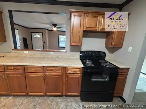 a kitchen with granite countertop a stove and cabinets
