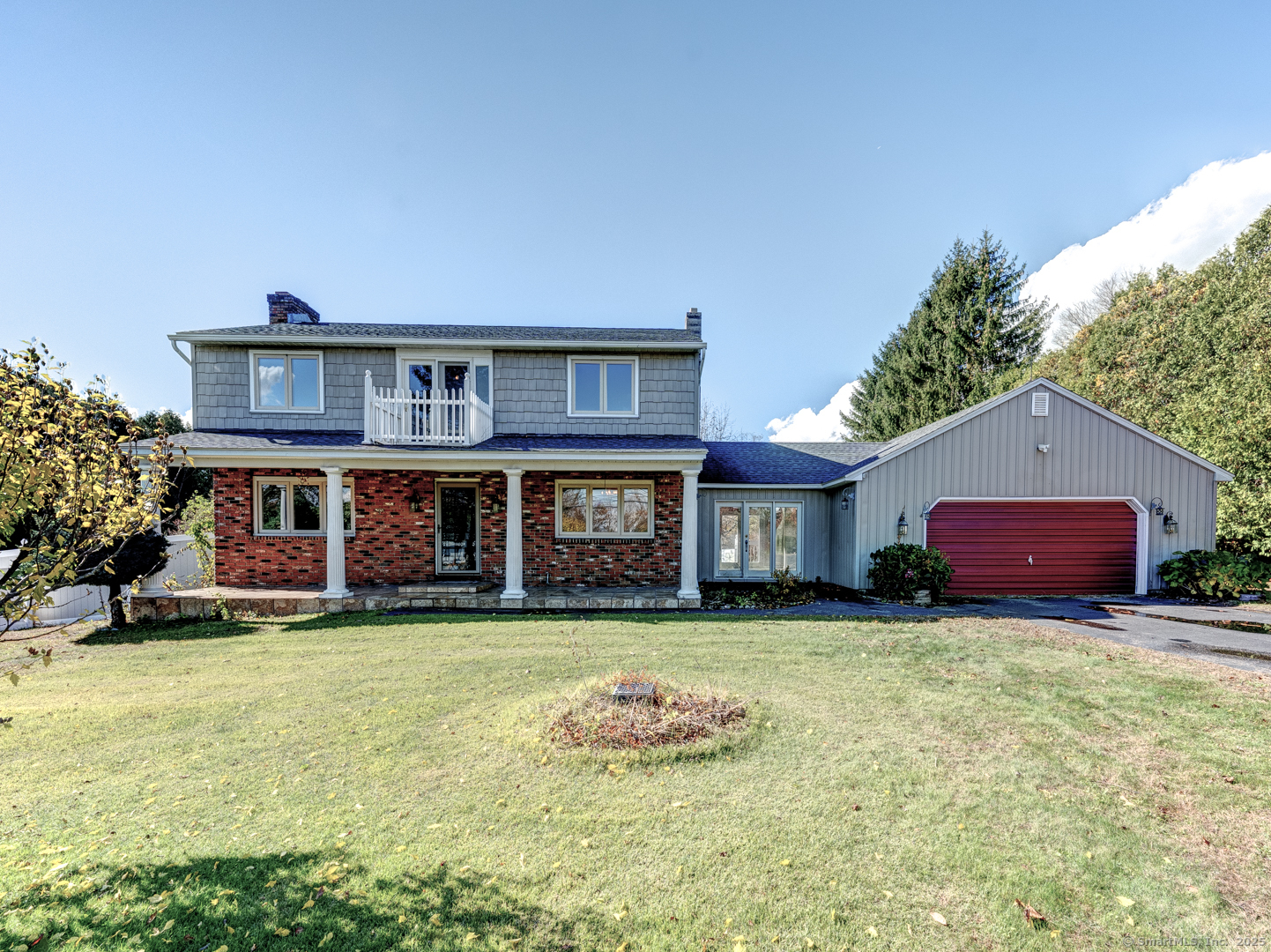 a view of a house with a yard and sitting area