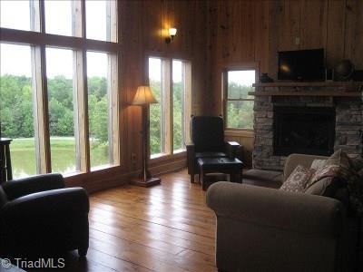 627 Mount Herman Church Road Mount Airy, NC 27030 - Photo 2 of 20 Windows from floor to ceiling looking out over the entire property and a cozy gas fire place w/ antique plank flooring