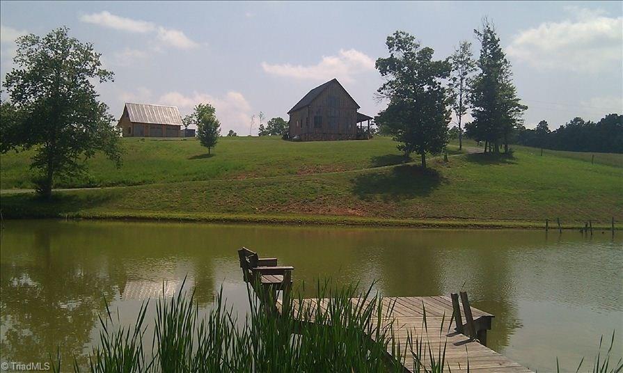 627 Mount Herman Church Road Mount Airy, NC 27030 - Photo 4 of 20 Wonderful view from the Dock of the cabin and detached garage carriage house, the 3 acre pond is stocked for fishing
