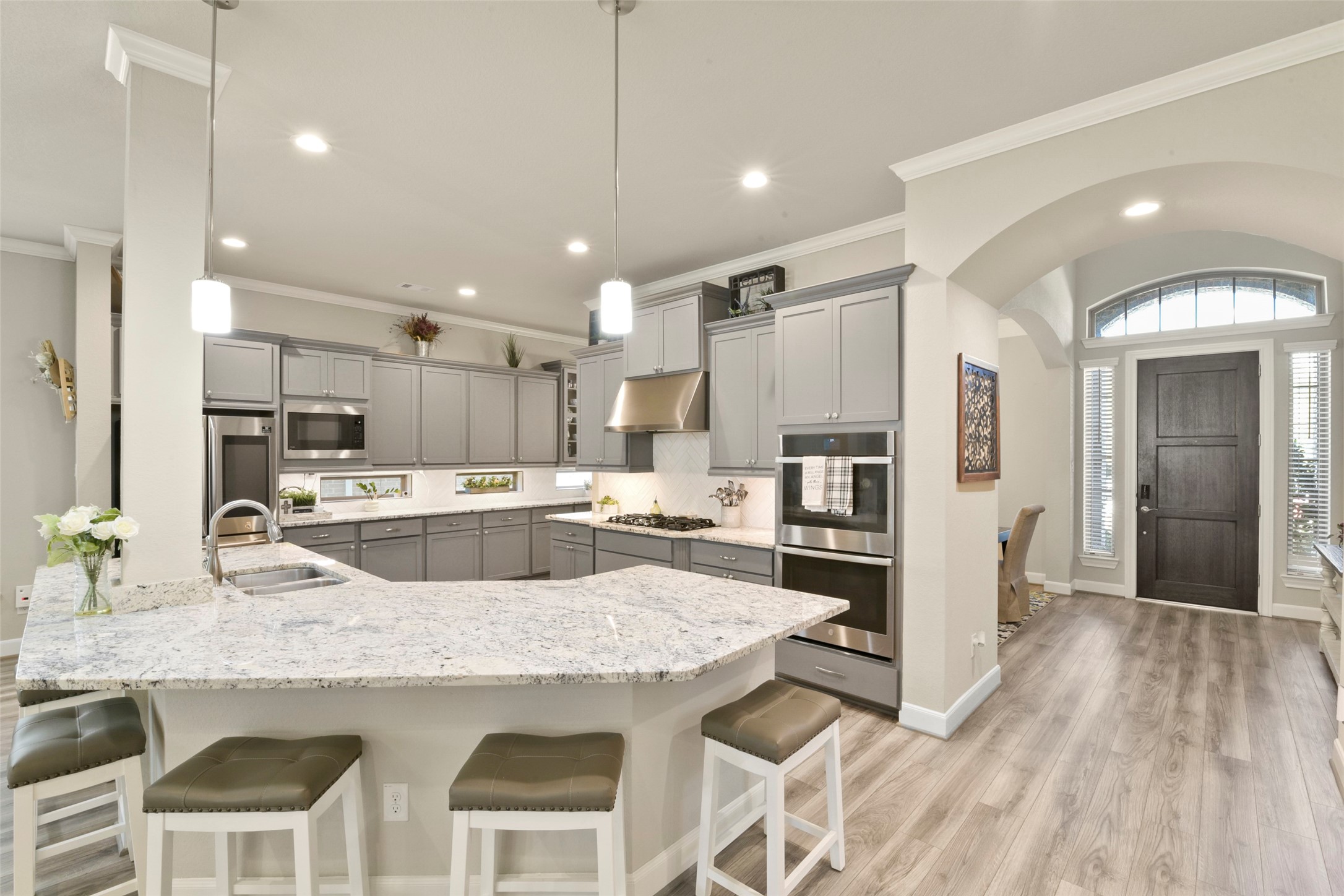 4582 Silver Moon Drive Spring, TX 77386 - Photo 12 of 48 a kitchen with granite countertop a refrigerator a stove a sink dishwasher and white cabinets with wooden floor