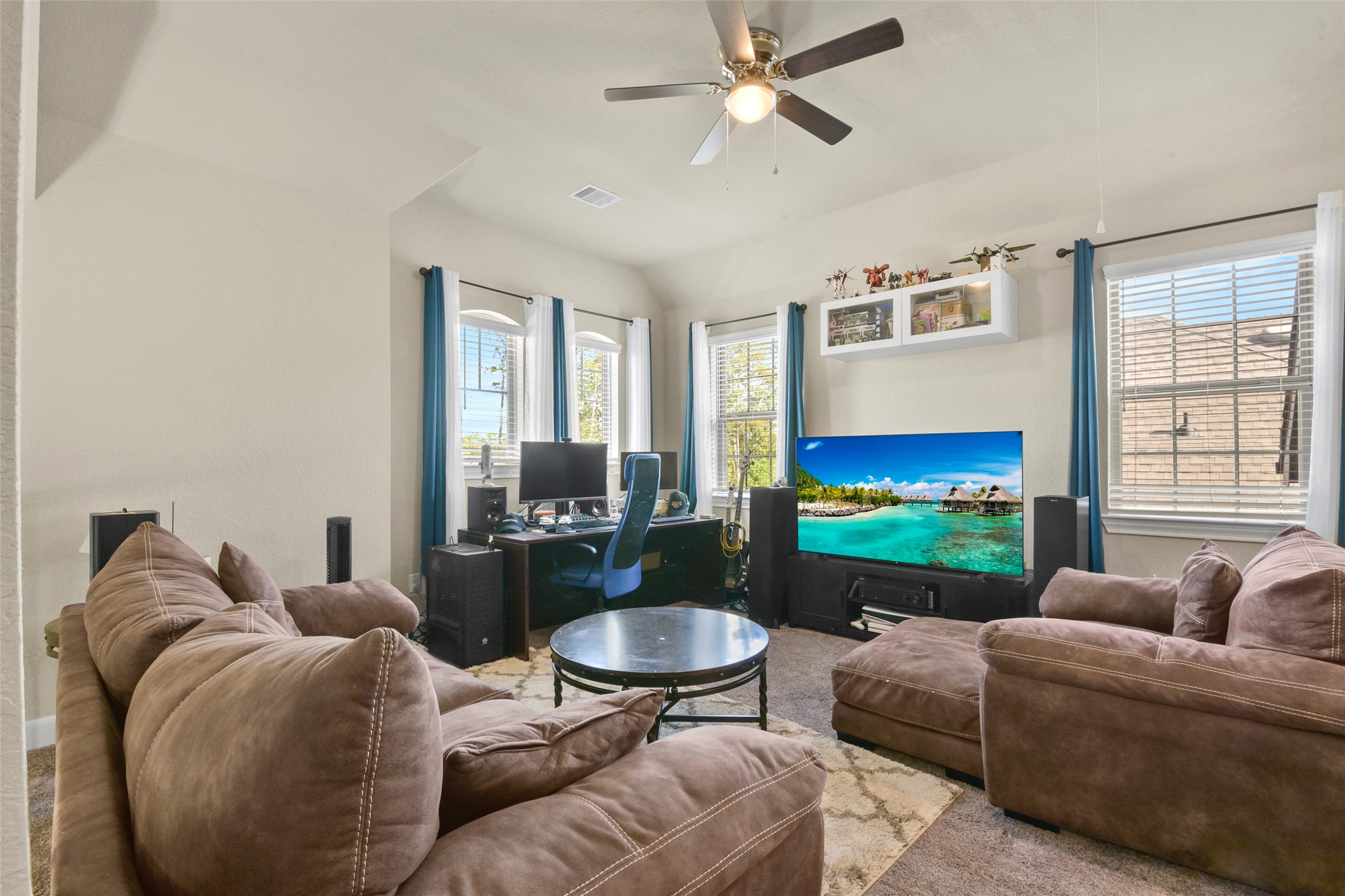 4582 Silver Moon Drive Spring, TX 77386 - Photo 33 of 48 a living room with furniture a flat screen tv and a fireplace