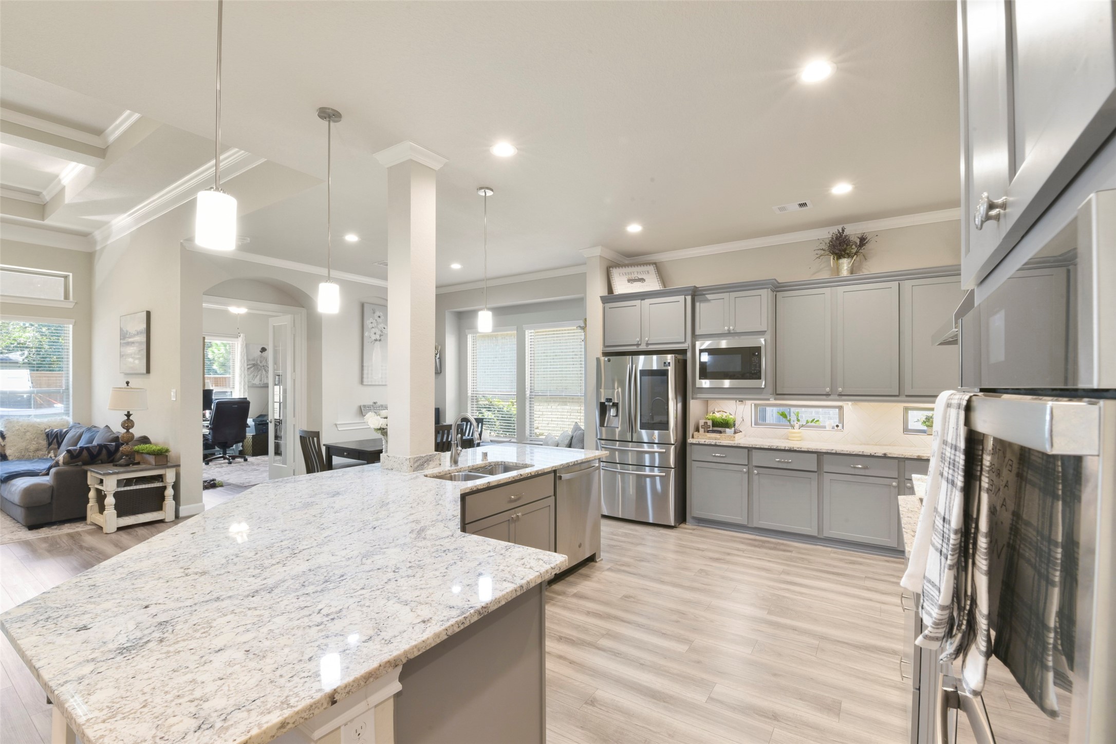 4582 Silver Moon Drive Spring, TX 77386 - Photo 10 of 48 a large kitchen with kitchen island a large counter space a sink appliances and cabinets