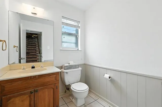 a bathroom with a sink a toilet and mirror