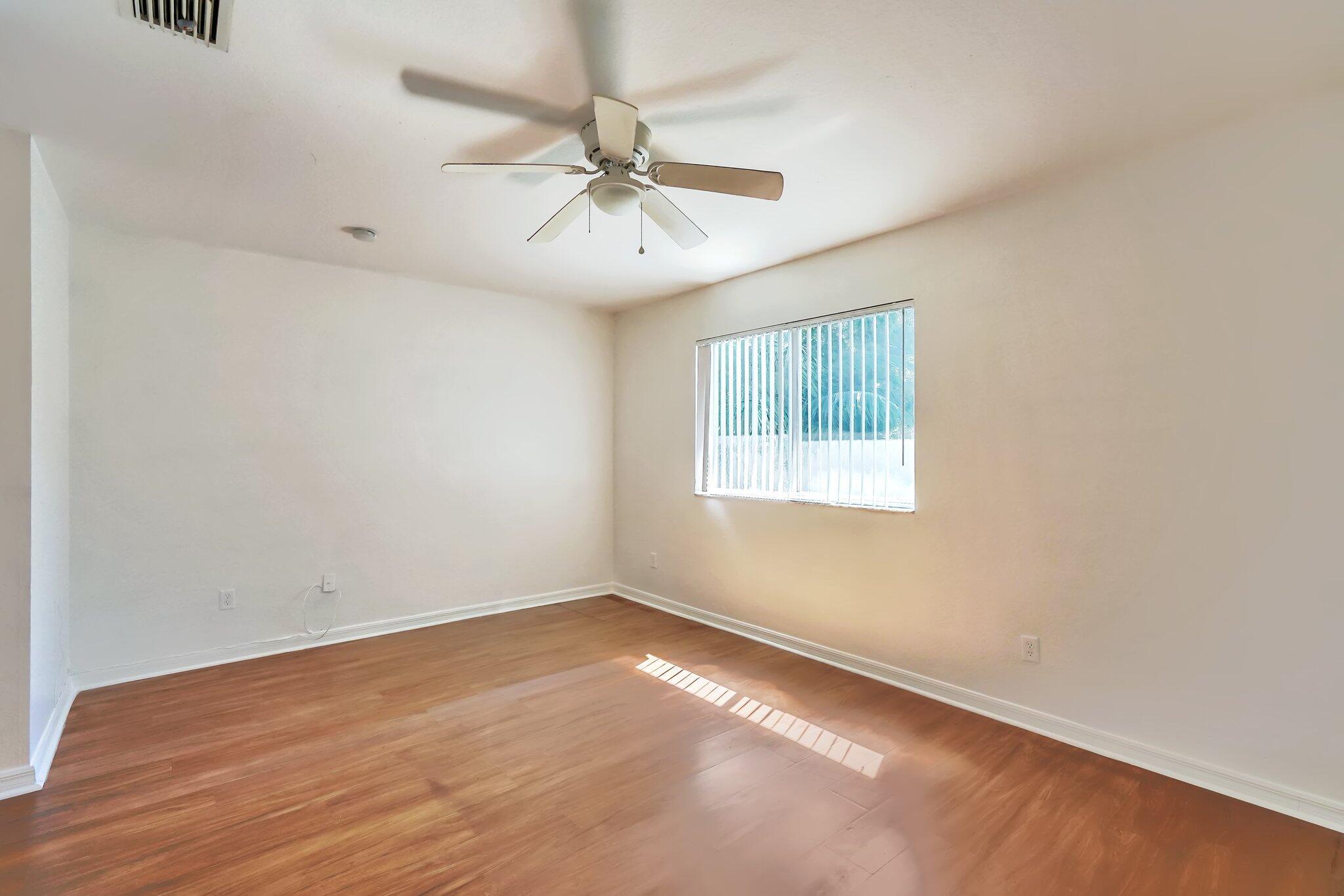 1969 Alamanda Way, Unit 1969 Riviera Beach, FL 33404 - Photo 11 of 26 an empty room with a window and a fan