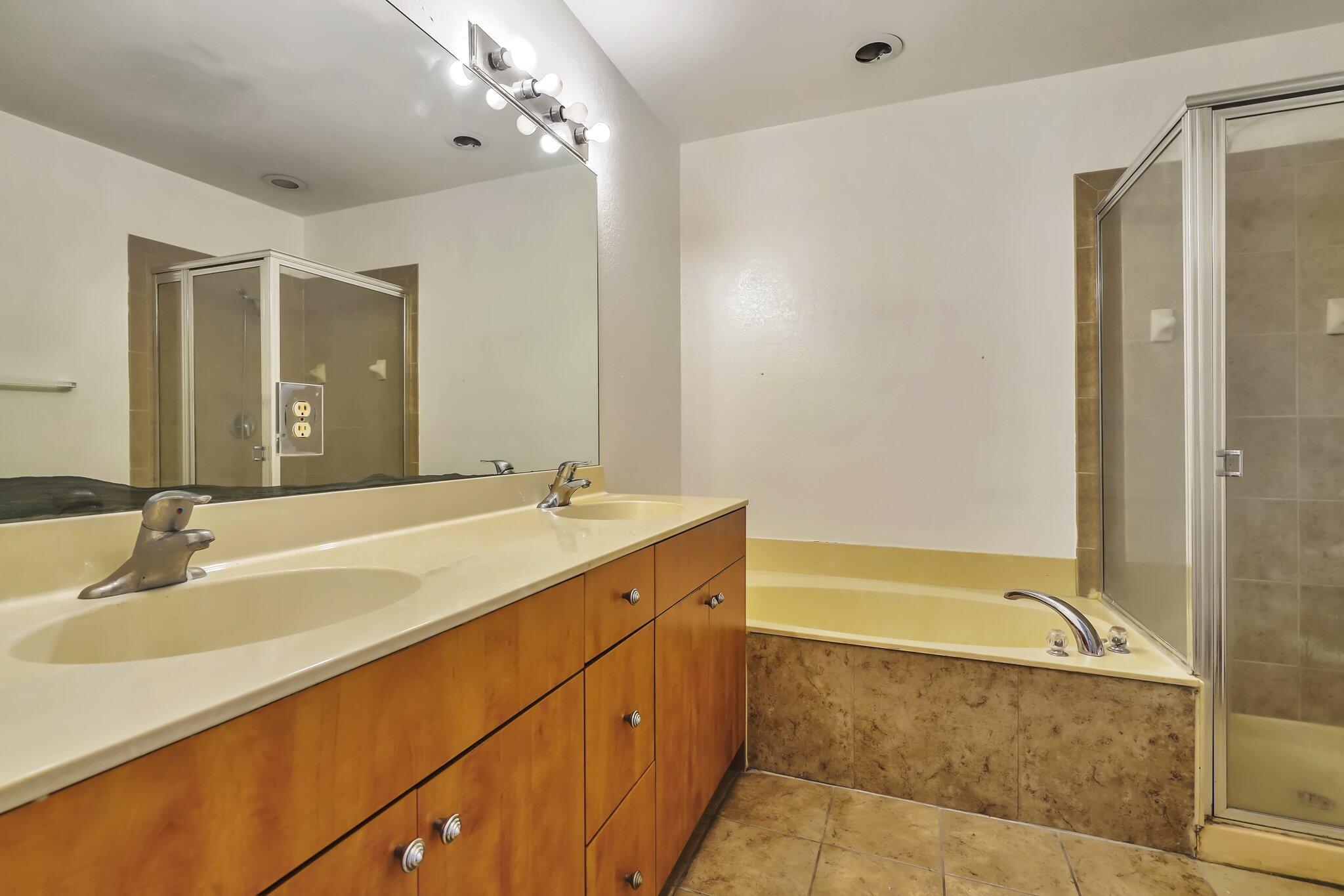1969 Alamanda Way, Unit 1969 Riviera Beach, FL 33404 - Photo 12 of 26 a bathroom with a tub sink and mirror