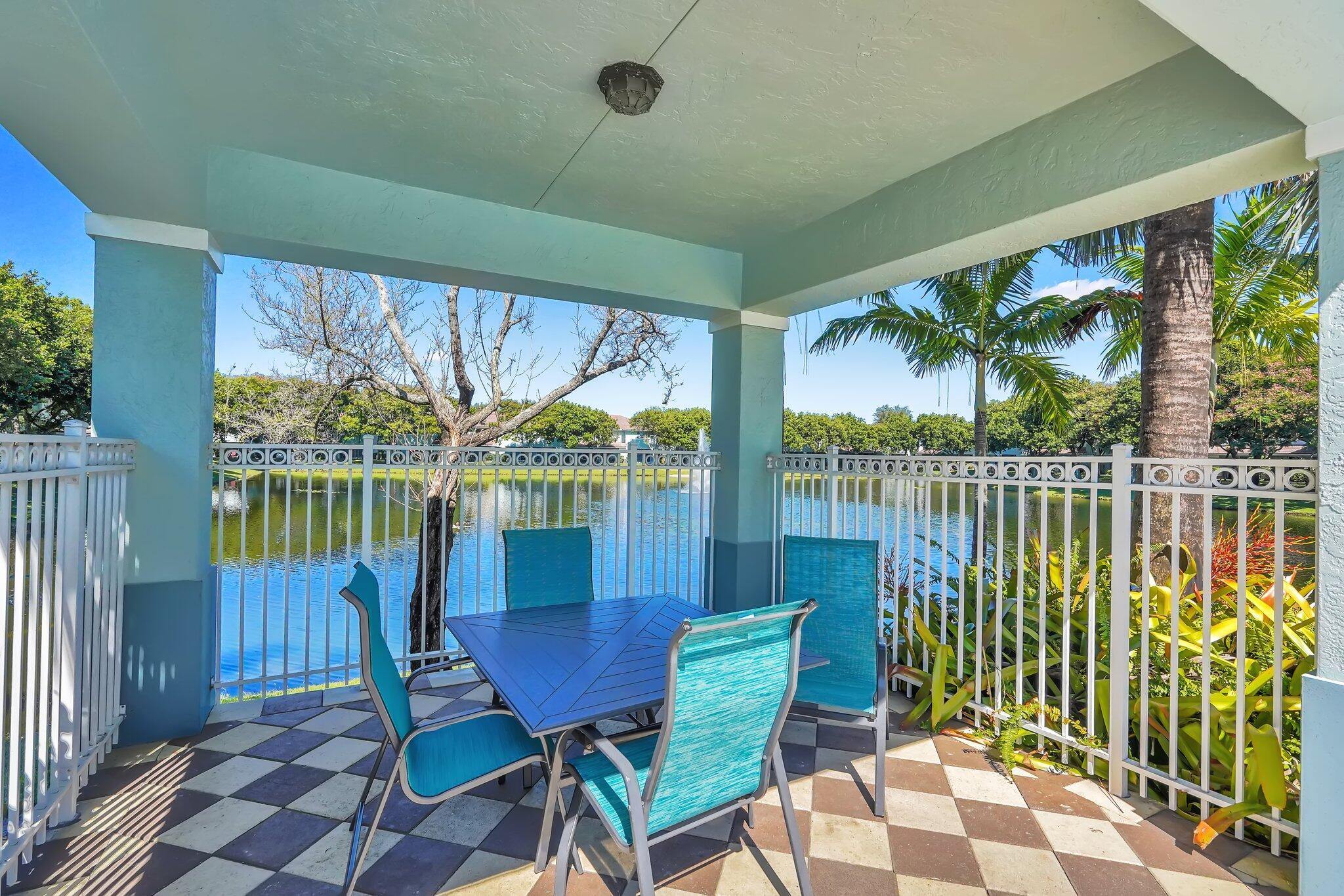 1969 Alamanda Way, Unit 1969 Riviera Beach, FL 33404 - Photo 19 of 26 a view of a chairs and table in patio with wooden floor