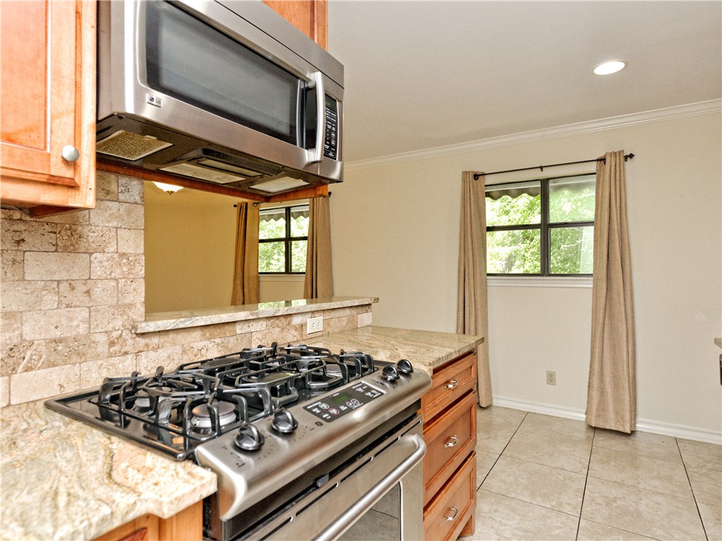 407 East 45th Street, Unit 210 Austin, TX 78751 - Photo 6 of 16 a kitchen with a stove and a microwave