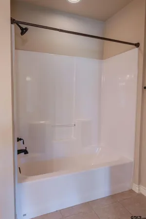 a bathroom with a shower and a bath tub