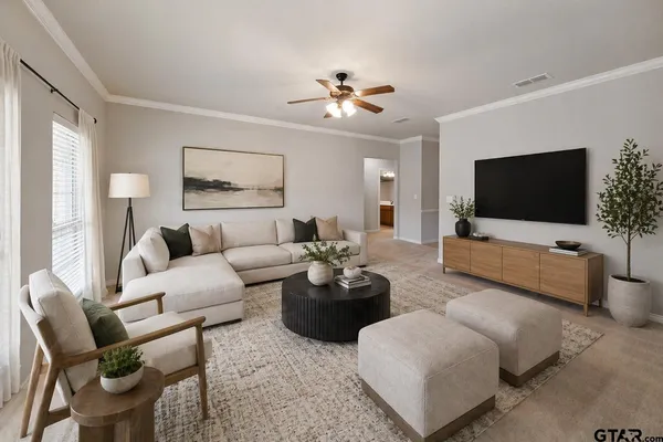 a living room with furniture and a flat screen tv