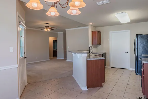 a view of a kitchen with a sink and refrigerator