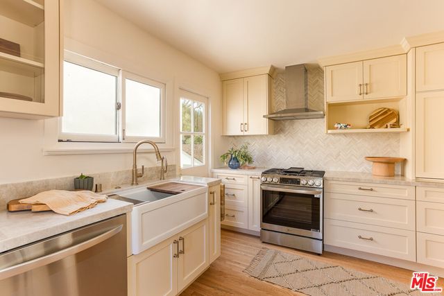a kitchen with a stove sink and cabinets