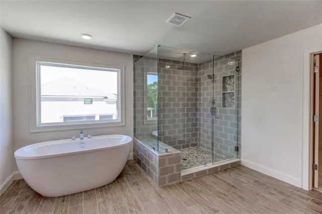 a bathroom with a bathtub and a shower