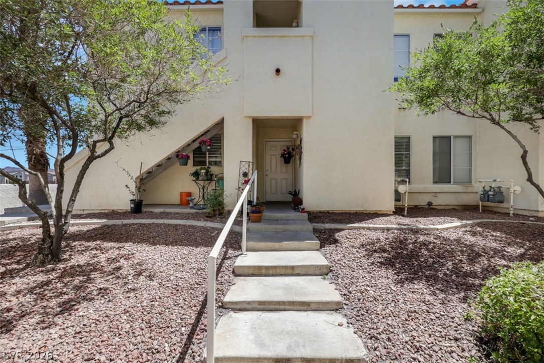 698 South Racetrack Road, Unit 1614 Henderson, NV 89015 - Photo 2 of 35 A welcoming entry path leads to this desert-landscaped residence, framed by mature trees.