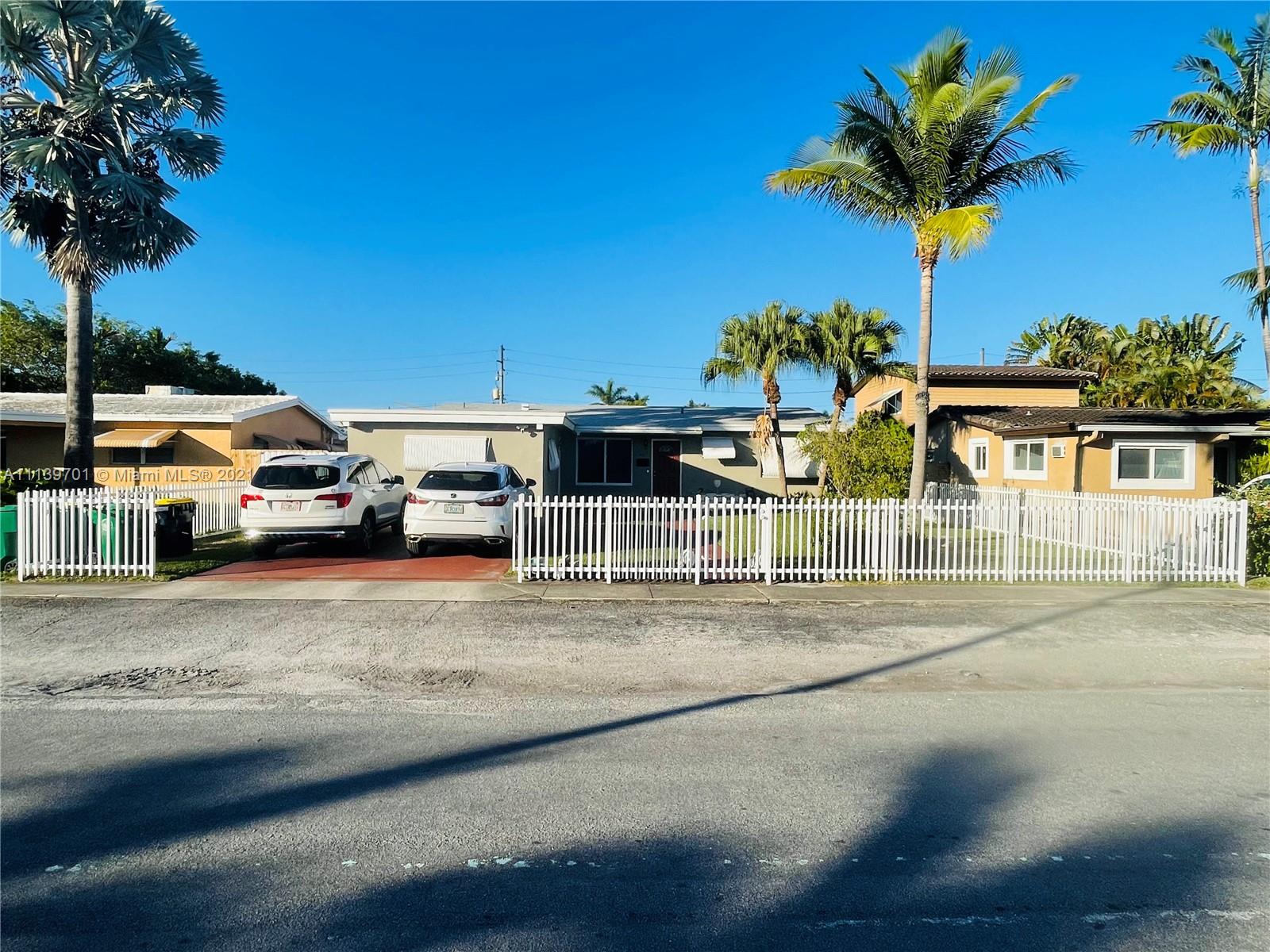 211 Southeast 3rd Street Dania Beach, FL 33004 - Photo 2 of 21 a front view of a house with a yard and garage