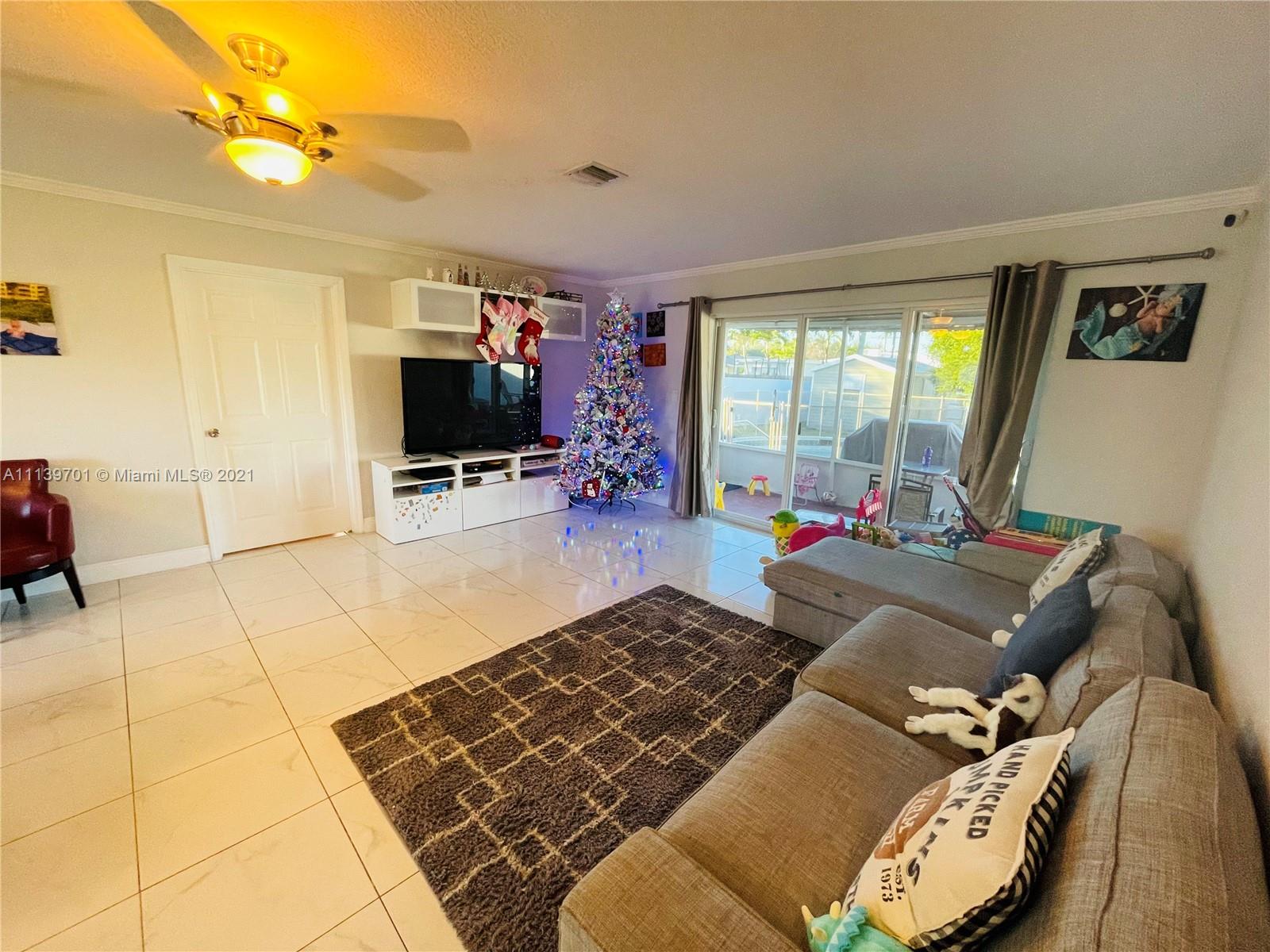 211 Southeast 3rd Street Dania Beach, FL 33004 - Photo 12 of 21 a living room with furniture and a flat screen tv
