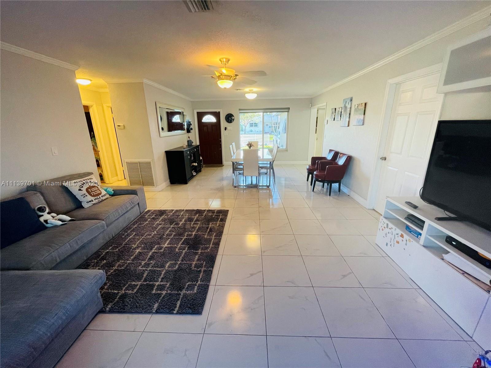 211 Southeast 3rd Street Dania Beach, FL 33004 - Photo 13 of 21 a living room with furniture and a flat screen tv