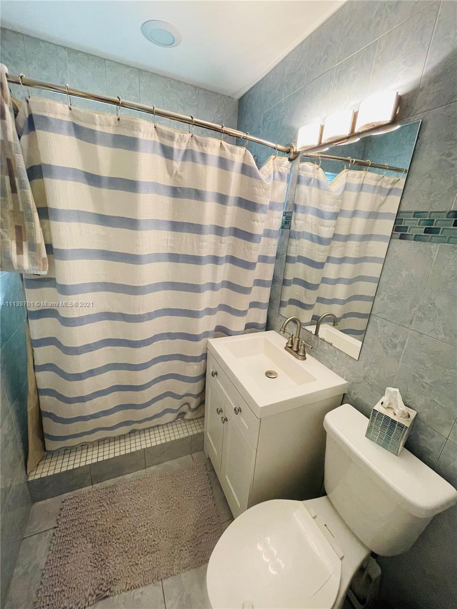 211 Southeast 3rd Street Dania Beach, FL 33004 - Photo 15 of 21 a bathroom with a sink toilet and shower