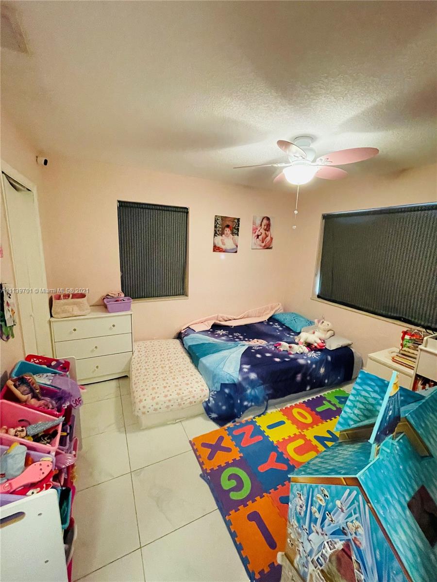 211 Southeast 3rd Street Dania Beach, FL 33004 - Photo 17 of 21 a bedroom with a bed and a flat screen tv
