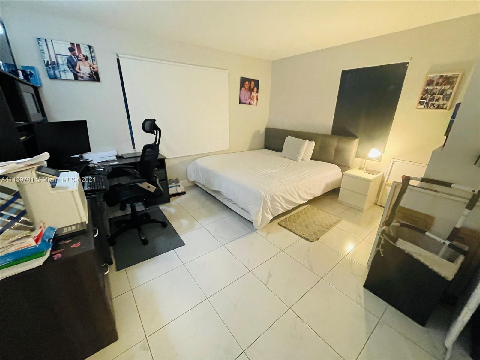 211 Southeast 3rd Street Dania Beach, FL 33004 - Photo 18 of 21 a bedroom with a bed and a couch