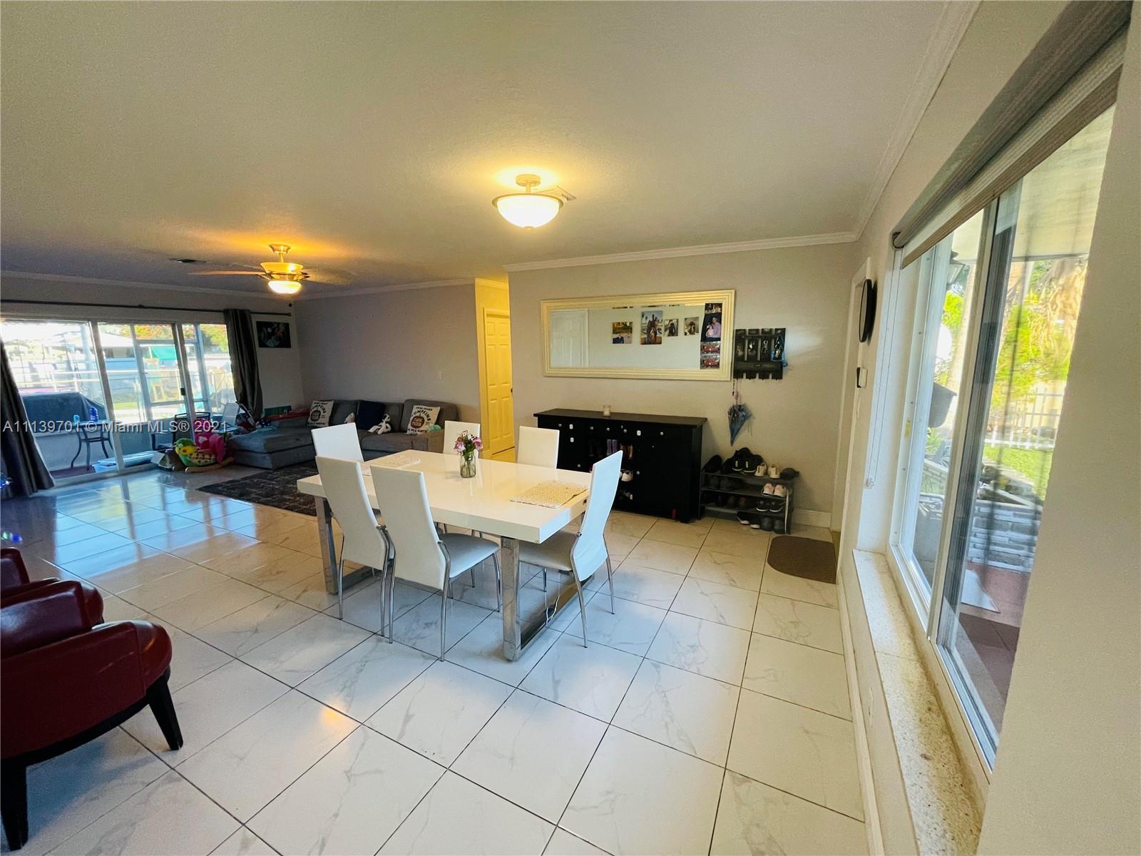 211 Southeast 3rd Street Dania Beach, FL 33004 - Photo 5 of 21 a living room with furniture and a large window