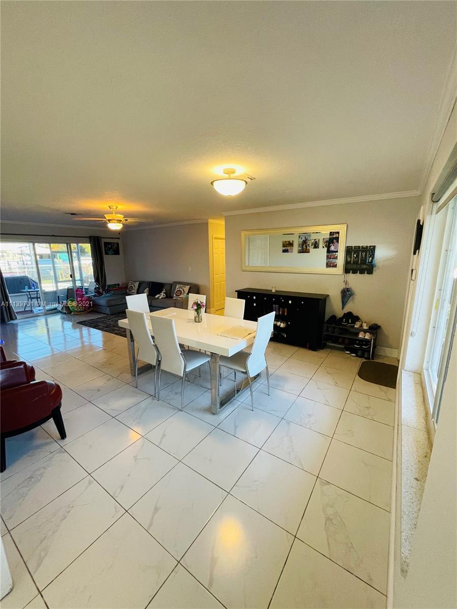 211 Southeast 3rd Street Dania Beach, FL 33004 - Photo 6 of 21 a living room with furniture and a flat screen tv