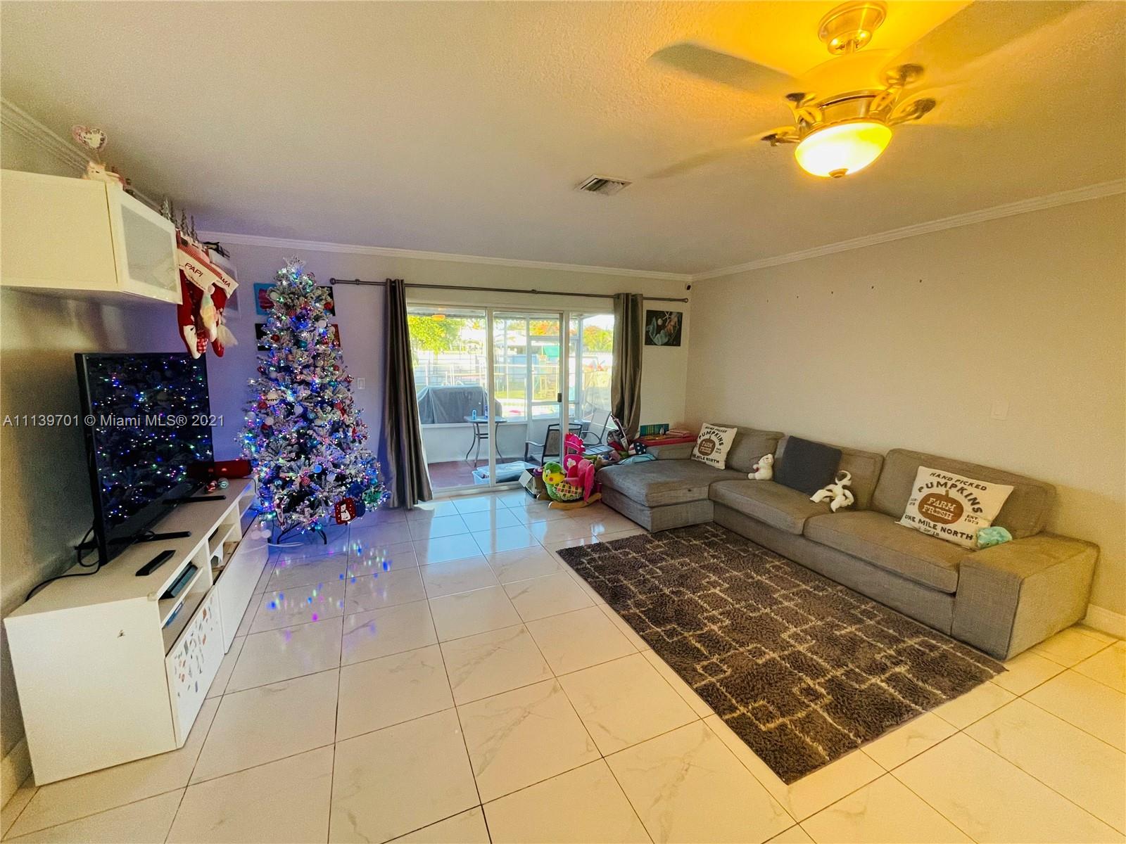 211 Southeast 3rd Street Dania Beach, FL 33004 - Photo 10 of 21 a living room with lots of furniture and flowers