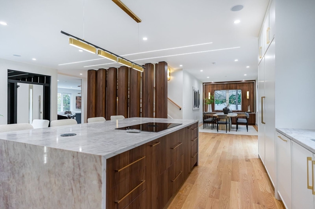 98 Hunnewell Street Needham, MA 02494 - Photo 12 of 36 a kitchen with a sink stove and wooden cabinets