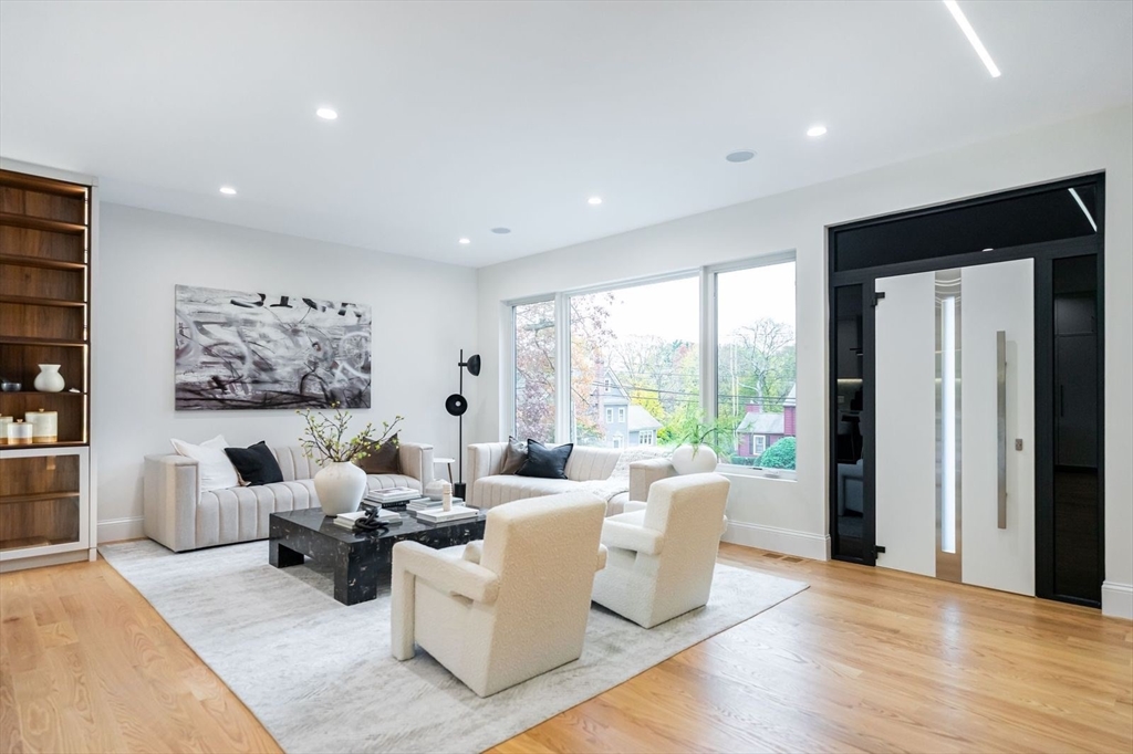 98 Hunnewell Street Needham, MA 02494 - Photo 14 of 36 a living room with furniture large window and wooden floor