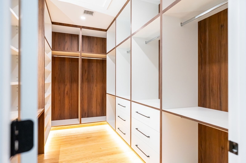 98 Hunnewell Street Needham, MA 02494 - Photo 20 of 36 a view of walk in closet with empty racks