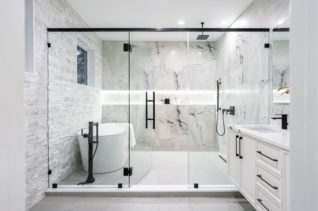 98 Hunnewell Street Needham, MA 02494 - Photo 21 of 36 a bathroom with a bathtub and a shower