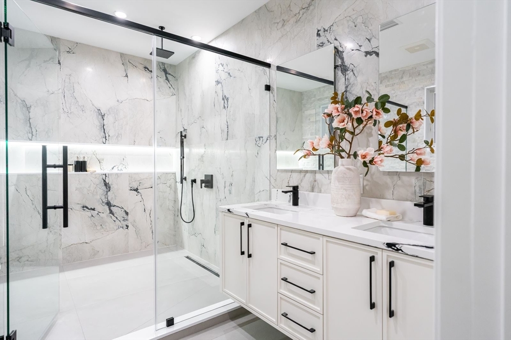 98 Hunnewell Street Needham, MA 02494 - Photo 22 of 36 a bathroom with a double vanity sink mirror and shower
