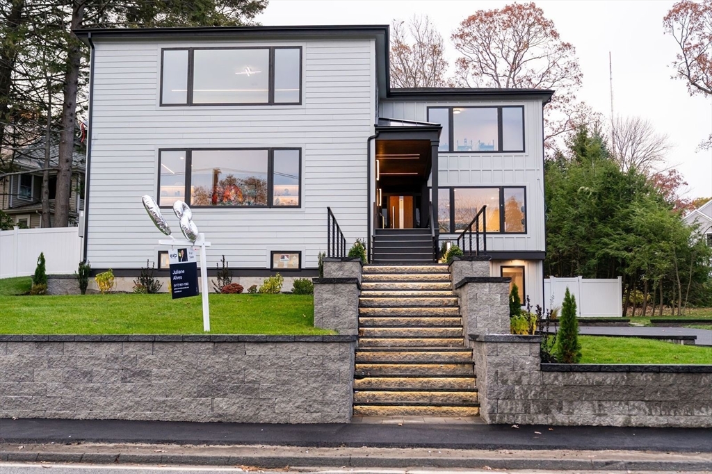 98 Hunnewell Street Needham, MA 02494 - Photo 8 of 36 a front view of a house with a yard