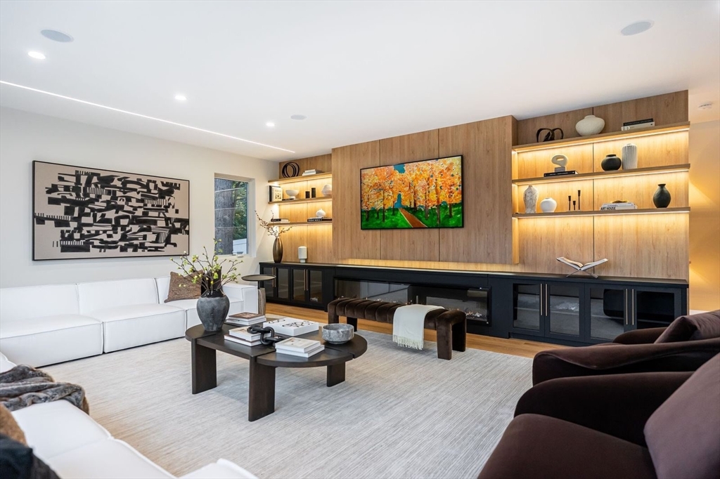 98 Hunnewell Street Needham, MA 02494 - Photo 9 of 36 a living room with furniture a flat screen tv and kitchen view