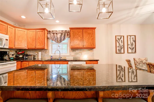 a kitchen with blue cabinets granite counter tops and a window