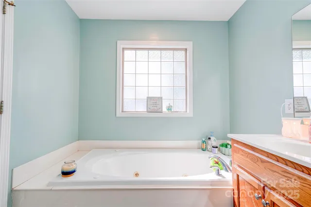 a bathroom with a bathtub and window