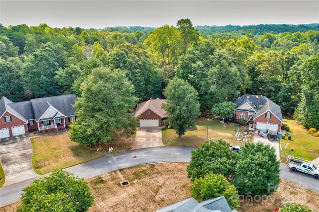 an aerial view of a house with swimming pool and garden
