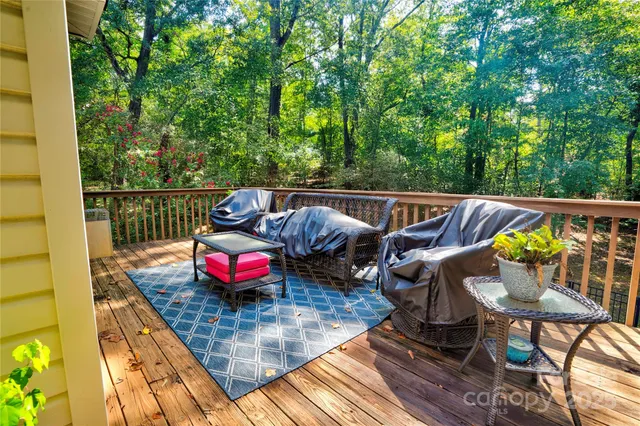 a balcony with furniture and wooden floor