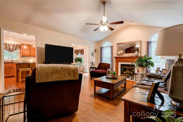 a living room with furniture a fireplace and a flat screen tv
