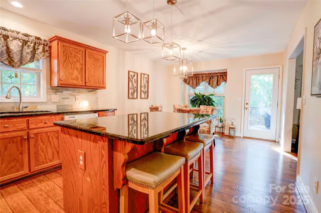 a kitchen with stainless steel appliances granite countertop a sink and cabinets