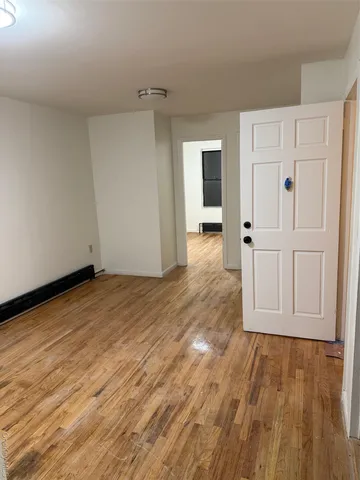 an empty room with wooden floor