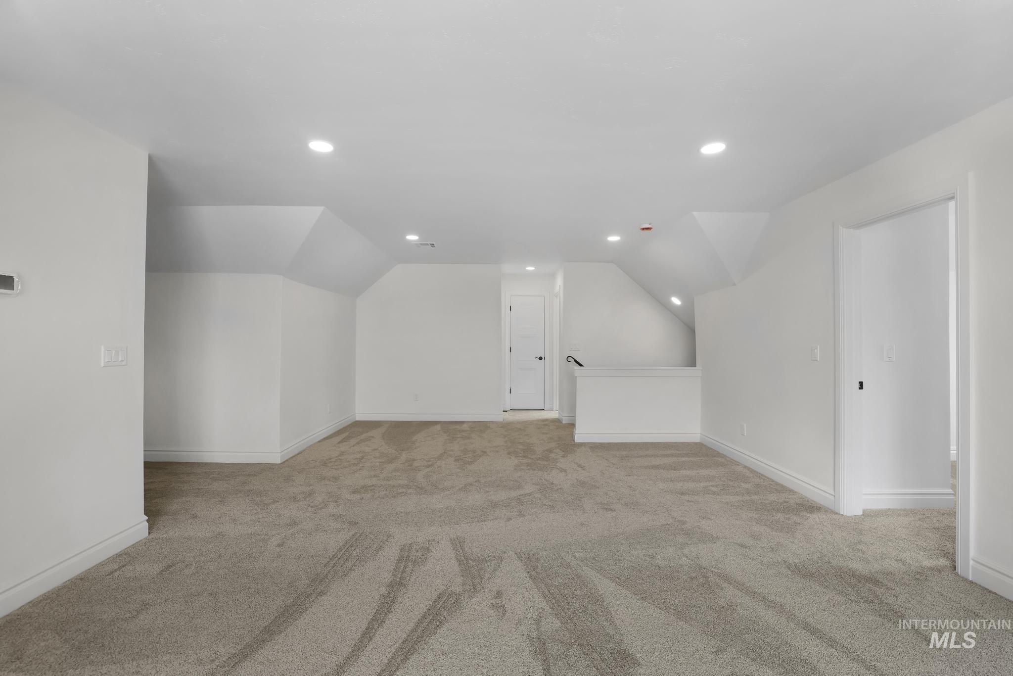 866 Quartz Road Kimberly, ID 83341 - Photo 29 of 48 Spacious carpeted room featuring recessed lighting, sloped ceiling details, white baseboards, and interior doors with black hardware