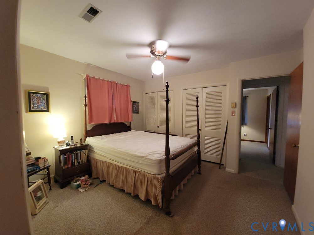 8241 Virginia Avenue West Point, VA 23181 - Photo 11 of 18 a bedroom with a bed and a chandelier