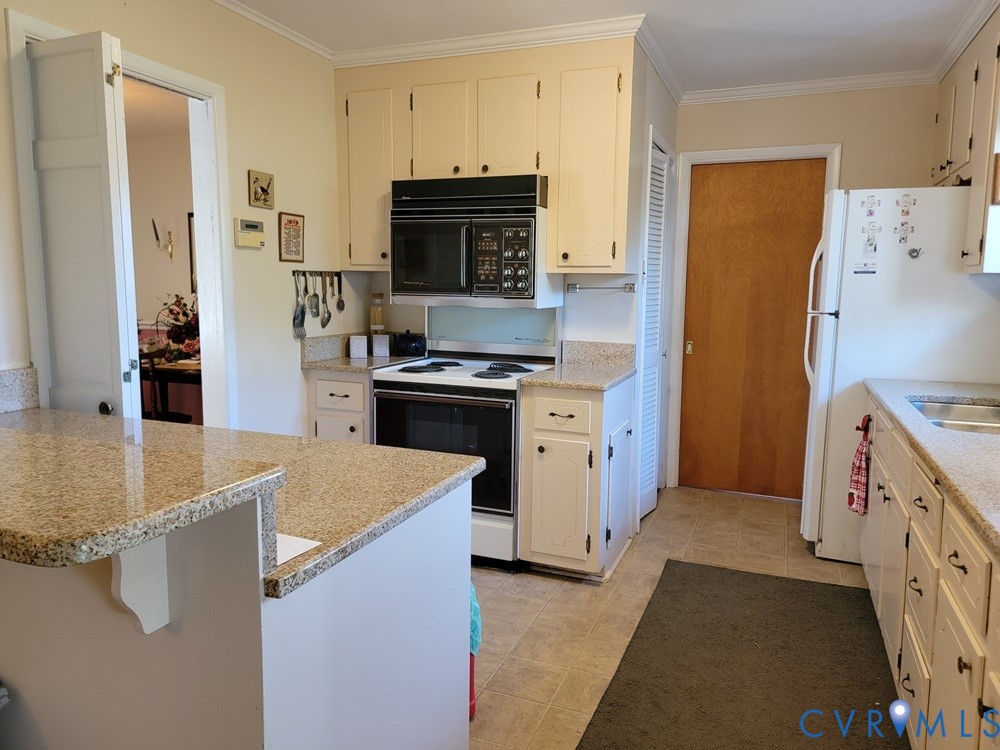 8241 Virginia Avenue West Point, VA 23181 - Photo 16 of 18 a kitchen with a sink stove and refrigerator