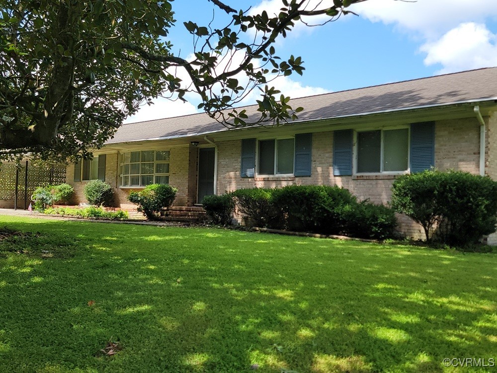 8241 Virginia Avenue West Point, VA 23181 - Photo 2 of 18 a front view of a house with garden